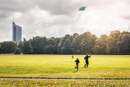 Eine Familie lässt im Leipziger Rosental Drachen steigen.
