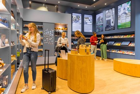 Interested visitors explore the tourist information in Leipzig.