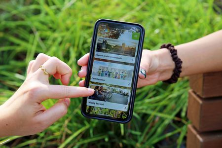 Auf dem Foto ist das Hauptmenü der Explore Leipzig App auf einem Smartphone zu sehen.