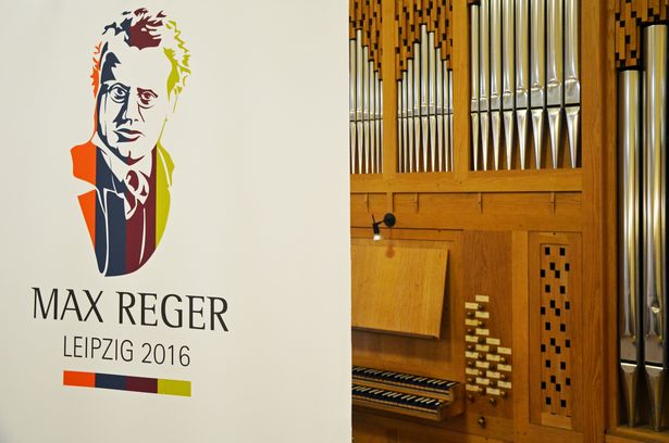 Poster of the jubilee for composer Max Reger next to an organ in Leipzig, City of Music, cultural institution