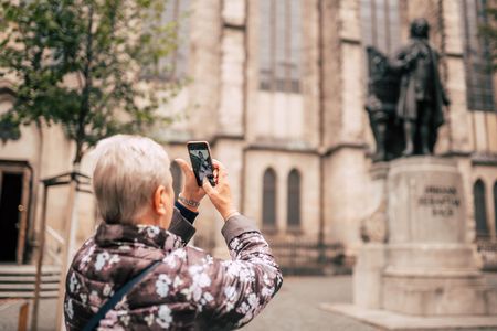A woman photographs the famous Bach monument.