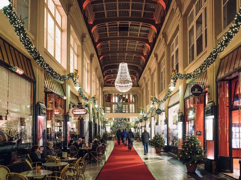 Leipzig's Mädler Arcade with Christmas decorations and bright lights.