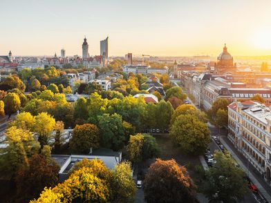 A birds-eye view of the City of Leipzig skyline with its famous sights, including the City Tower, the New City Hall and the Federal Administrative Court, at sunrise